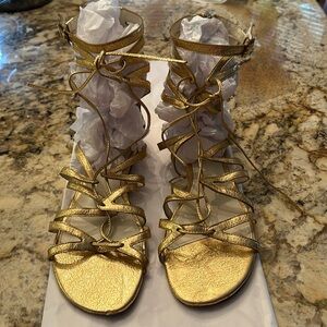 Via Spliga gold gladiator sandals.